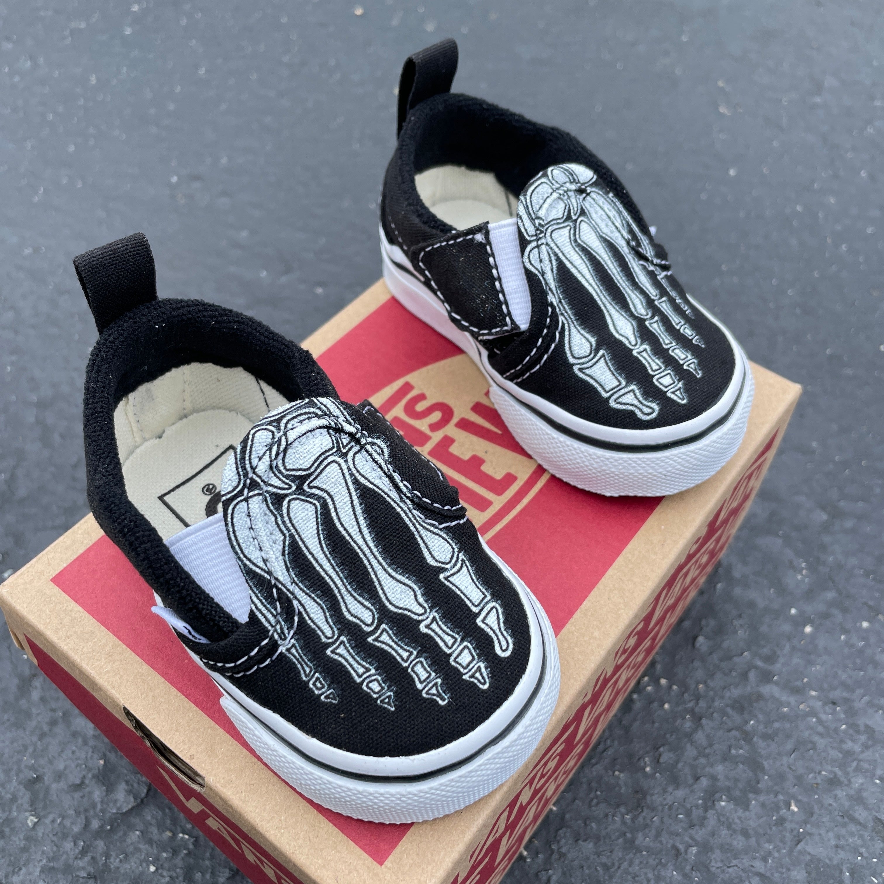 Vans skeleton hotsell slip ons